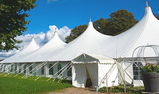 a line of sleek and modern portable toilets ready for use at an upscale corporate event in Crawford